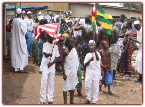Children holding American and Togolese Flags. 